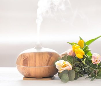 aroma-oil-diffuser-lamp-table-blurred-background-with-beautiful-spring-bouquet-tulips_169016-4880
